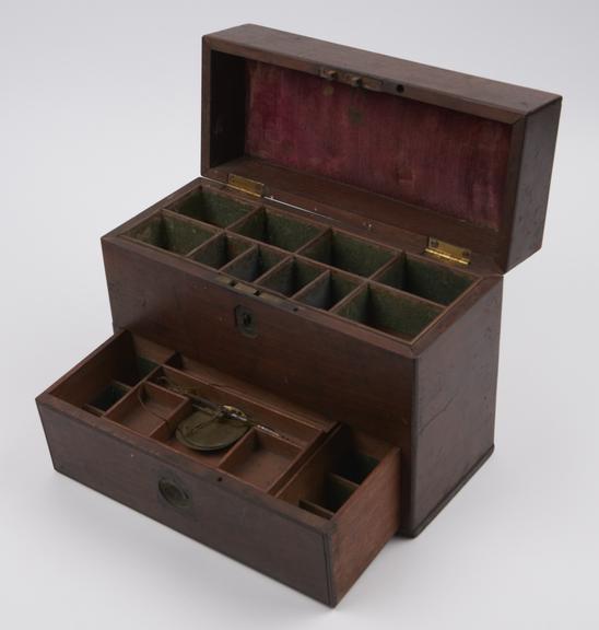 Rectangular wooden medicine chest with hinged lid and front