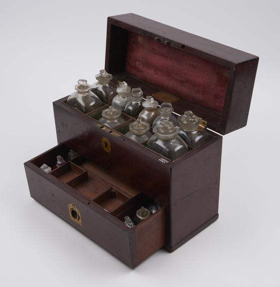 Tall rectangular mahogany medicine chest with 16 glass bottles