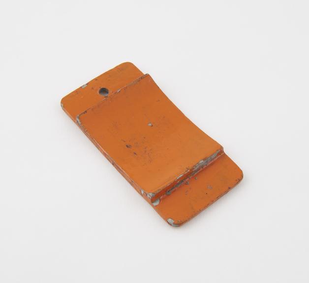 Model, of orange painted aluminium plate