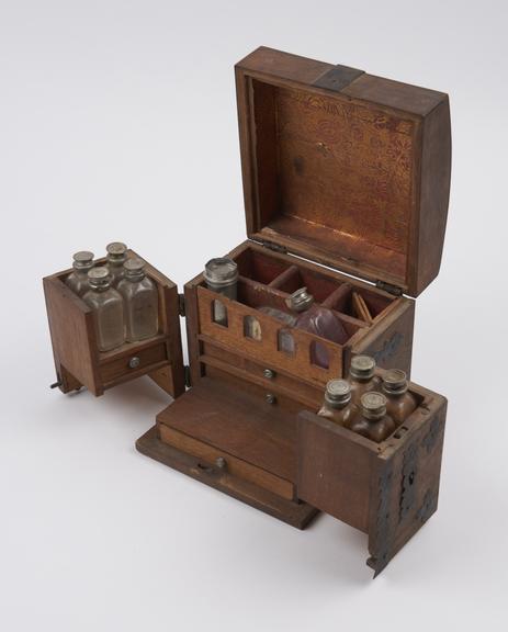 Small walnut medicine chest with 2 hinged wing doors at front