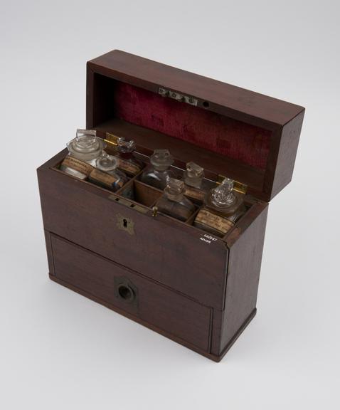 tall rectangular mahogany medicine chest, with 13 glass bottles