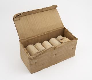 Eleven rolled cotton bandages in cardboard box