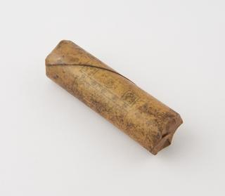Cylindrical stick of explosive substitute in cream waxed paper wrapper with black printing