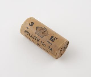 Cylindrical stick of explosive substitute in cream paper wrapper with black printing