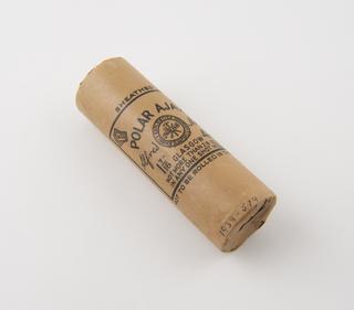 Cylindrical stick of explosive substitute in cream paper wrapper with black printing.  Printed: 'SHEATHED'