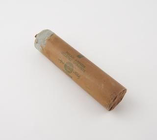 Cylindrical stick of explosive substitute in brown waxed paper wrapper, printed: ‘POLAR AMMON’; ‘GELATINE DYNAMITE’;