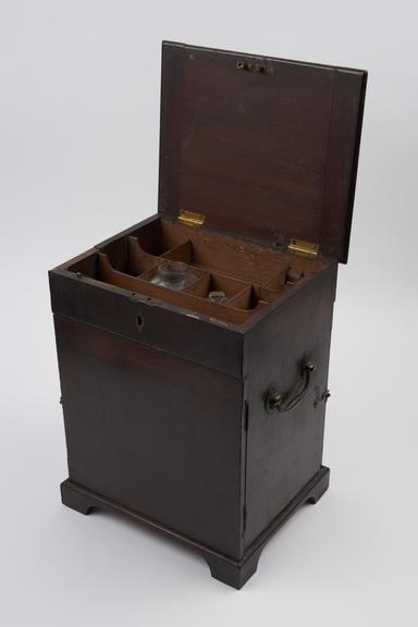 Medicine chest, partly empty, containing sixteen glass bottles