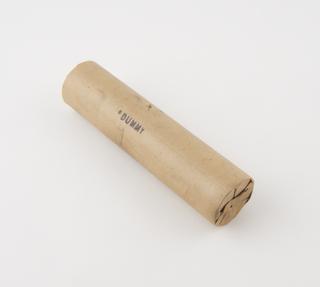Cylindrical stick of explosive substitute, with faded remnants of red printing