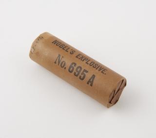 Cylindrical stick of explosive substitute, with black printing: ‘NOBEL'S EXPLOSIVE.’; ‘No. 695A’;