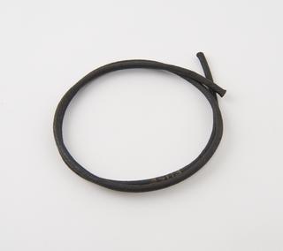 Coil of black covered dummy burning fuze