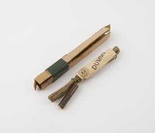 Copper dummy detonator connected to cream gutta-percha covered electric ignition wires