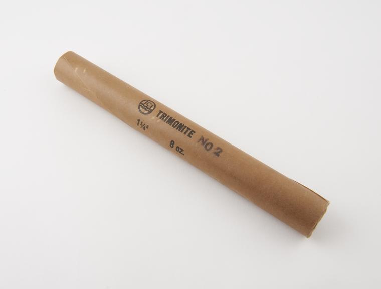 Cylindrical stick of explosive substitute in brown paper