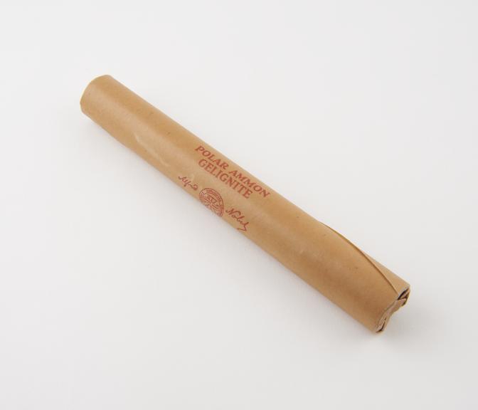 Cylindrical stick of explosive substitute in brown paper