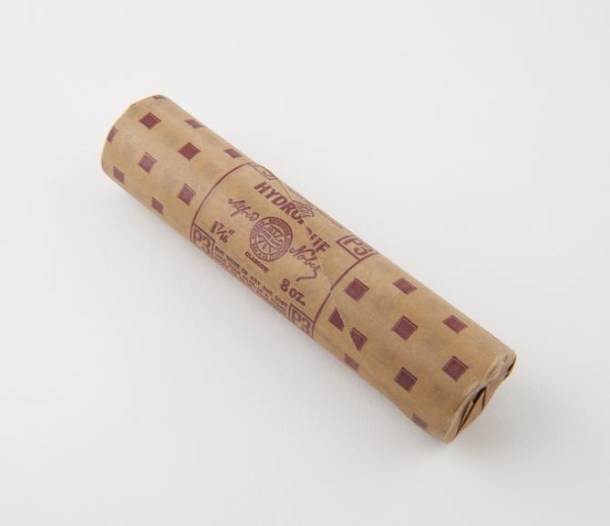 Cylindrical stick of explosive substitute in brown lightly