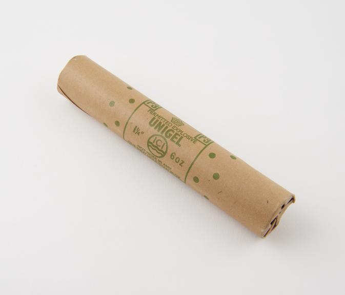 Cylindrical stick of explosive substitute in brown lightly