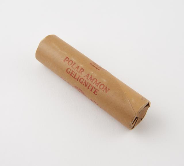 Cylindrical stick of explosive substitute in brown lightly