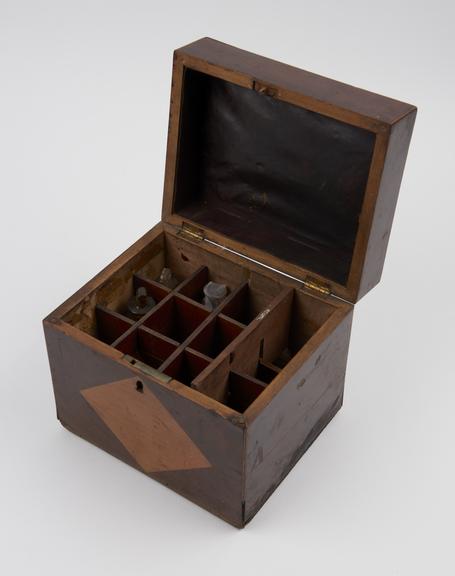 Rectangular wooden medicine chest with hinged lid which is