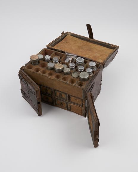 Leather-covered wooden medicine chest with hinged lid and