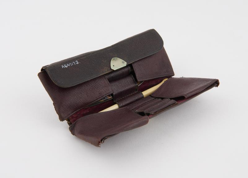 Small brown leather case containing bistoury and other instruments