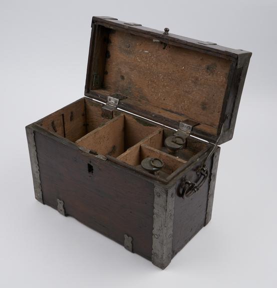 Iron bound wooden medicine chest with lock at front and 2