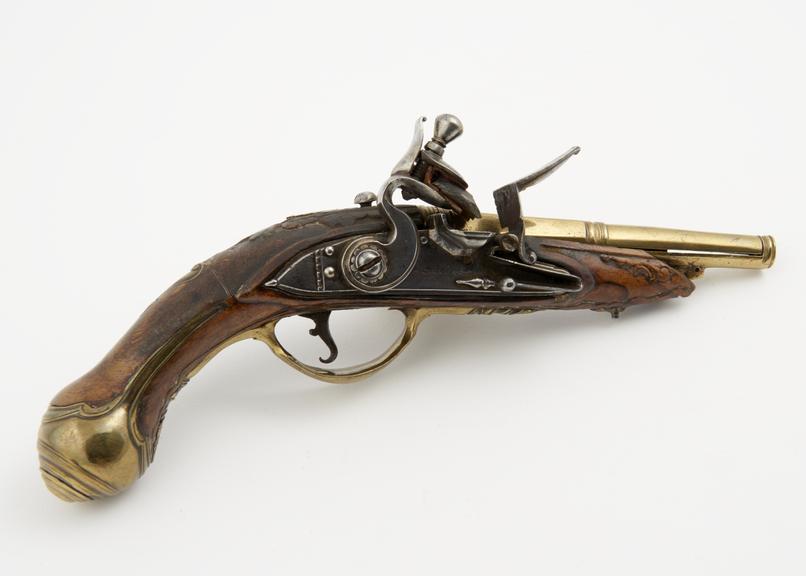 Tinder-pistol (length 9 ins) of iron, with carved wooden butt