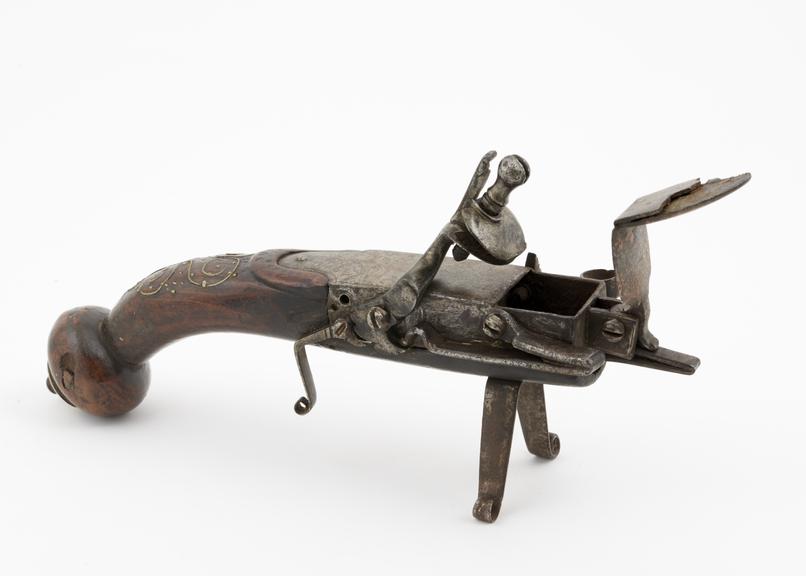 Tinder-pistol (length 8 1/4 ins) of iron, with wooden butt