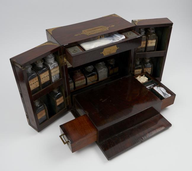 Brass bound drop front tryptich medicine chest with 24 bottles