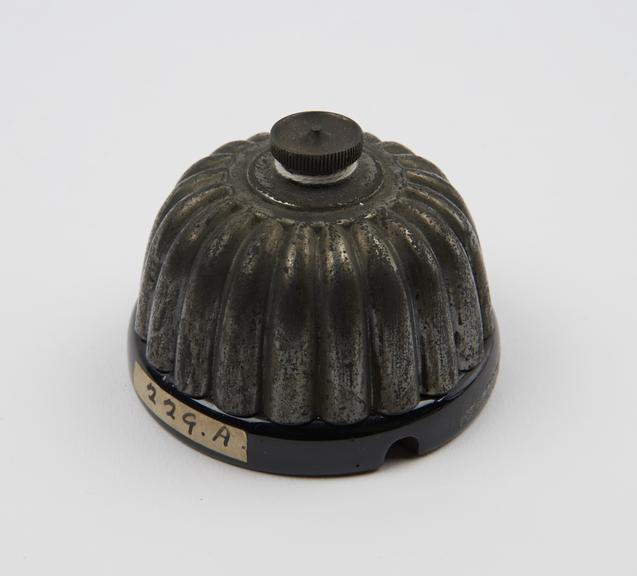 Fuse, black China, with ribbed dome-shaped cover