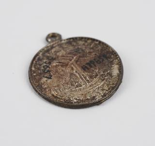 Metal pendant depicting George and the Dragon on obverse