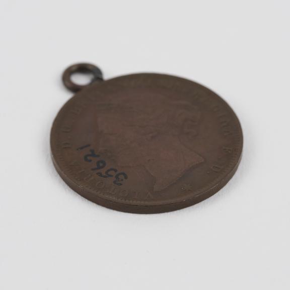 Amulet, metal, coin with head of Queen Victoria and coat of