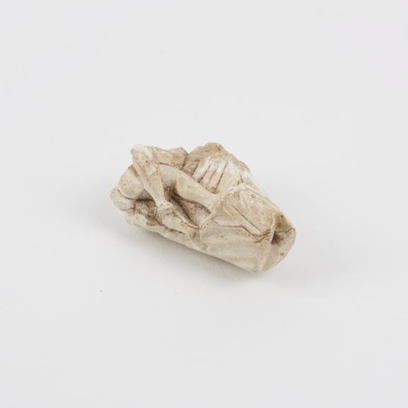 Carved marble fragment showing legs of a copulating couple with
