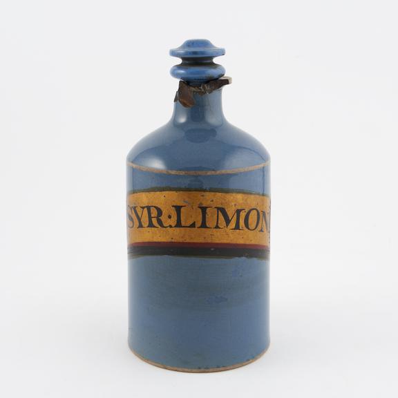 Blue pottery bottle stoppered and labelled as containing