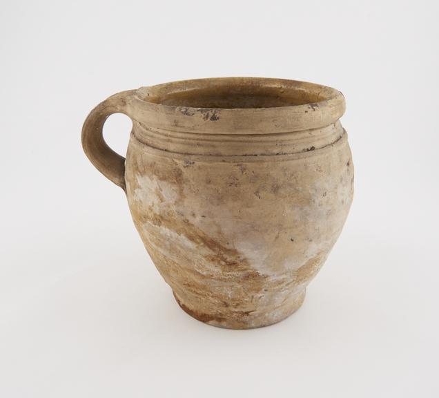 Earthenware chamber pot with yellow lead glaze inside, English