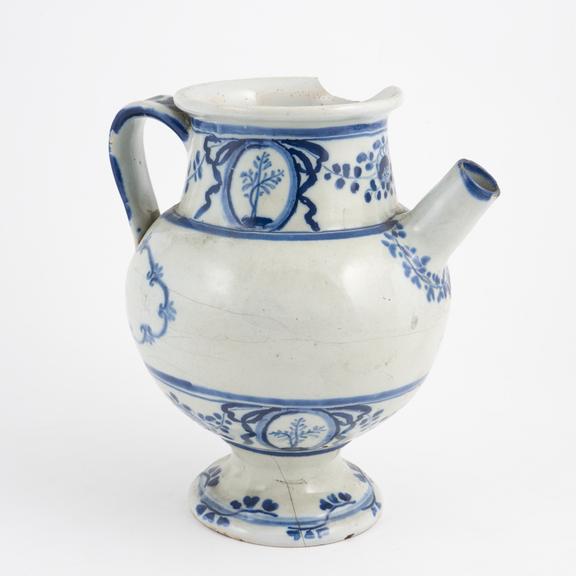 Blue and white syrup jar with dog and spoon on handle