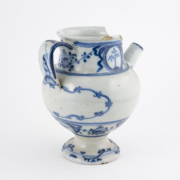 Blue and white syrup jar with dog and spoon on handle north