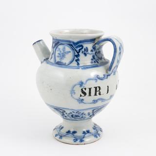 Blue and white syrup jar with dog and spoon on handle