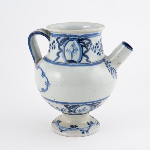 Blue and white syrup jar with dog and spoon on handle