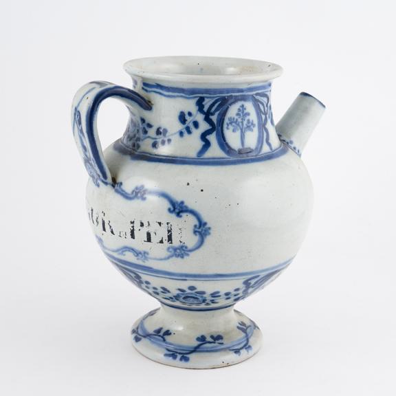 Blue and white syrup jar with dog and spoon on handle