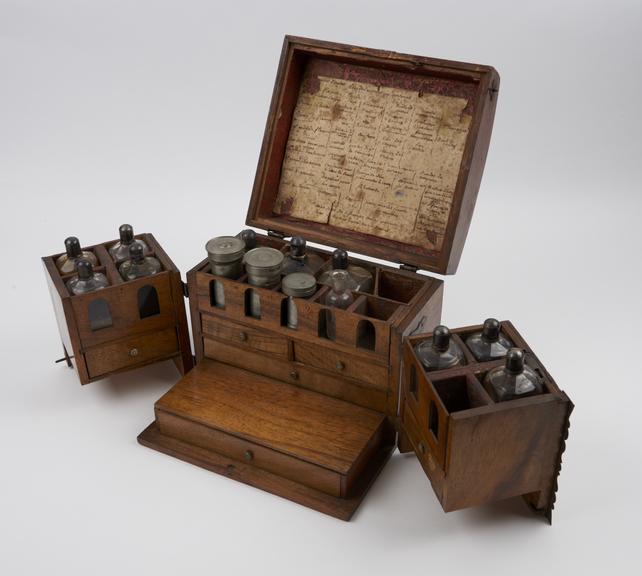 Oak medicine chest, hinged lid, double swivel fronts