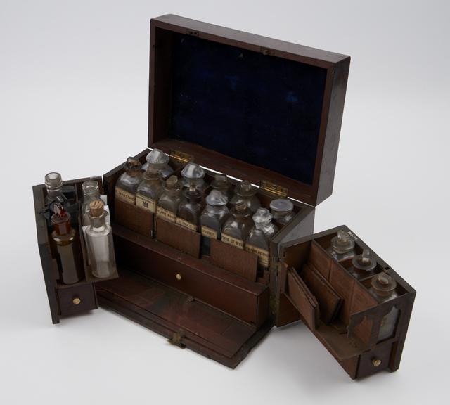 Walnut medicine chest with 22 glass bottles, 14 labelled