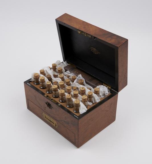 Walnut homeopathic medicine chest, with 34 glass bottles