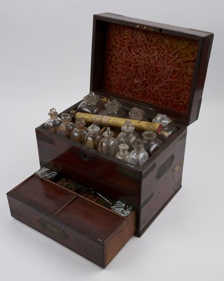 Brass bound medicine chest with 28 glass bottles, 18 labelled