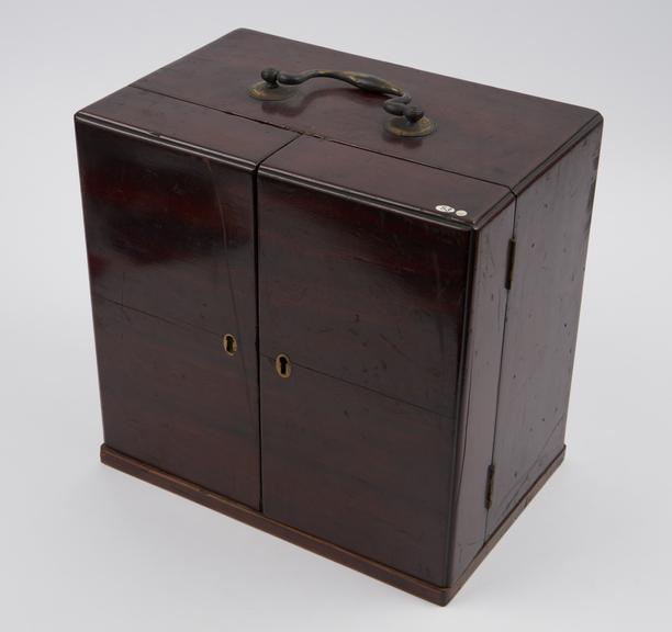 Brass bound medicine chest with 9 glass bottles, none labelled