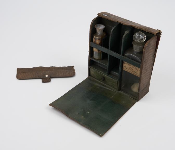 Small medicine chest with flap over lid