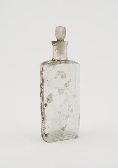 Clear glass medicine bottle, one of 32, from Savory and Moore