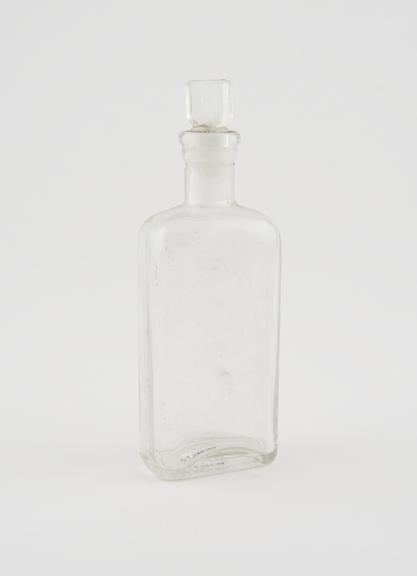 Clear glass medicine bottle, one of 32, from Savory and Moore