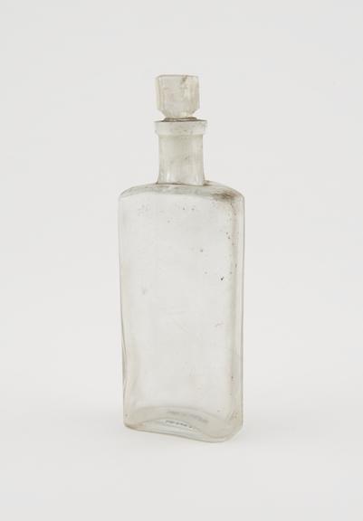 Clear glass medicine bottle, one of 32, from Savory and Moore