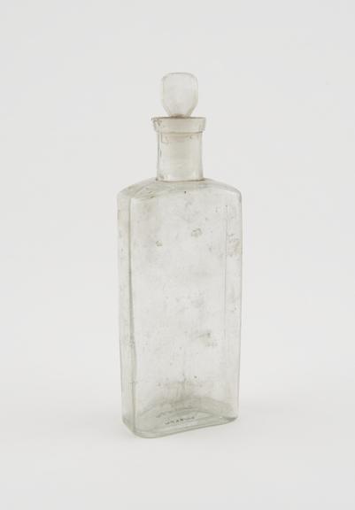 Clear glass medicine bottle, one of 32, from Savory and Moore