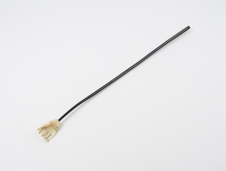 Back scratcher, in the form of a cylindrical rod tapering