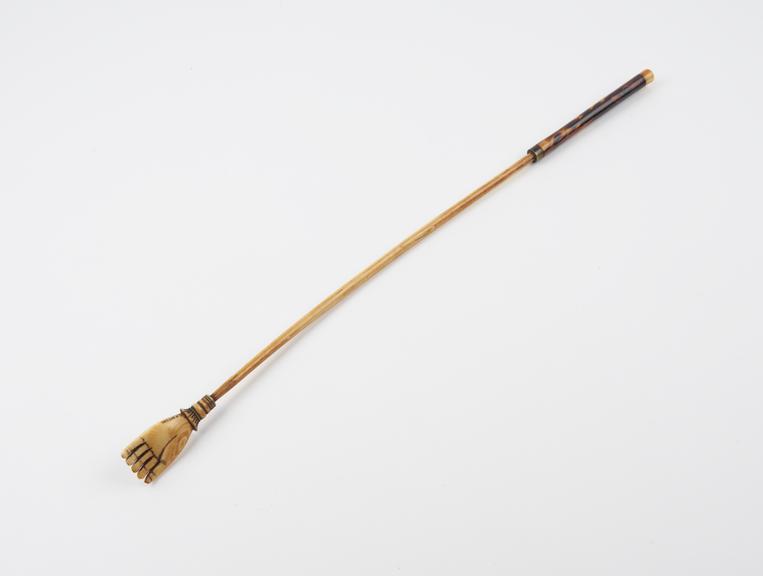 Ivory back scratcher with long cylindrical stem